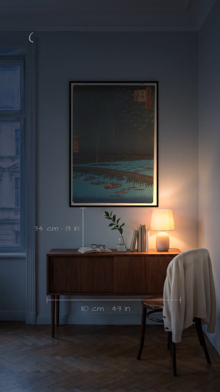 Third floor, no lift – One print, two thirds of the sideboard, one lamp. An evening in a city flat.